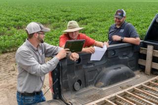 ServiTech agronomists with a farmer-customer